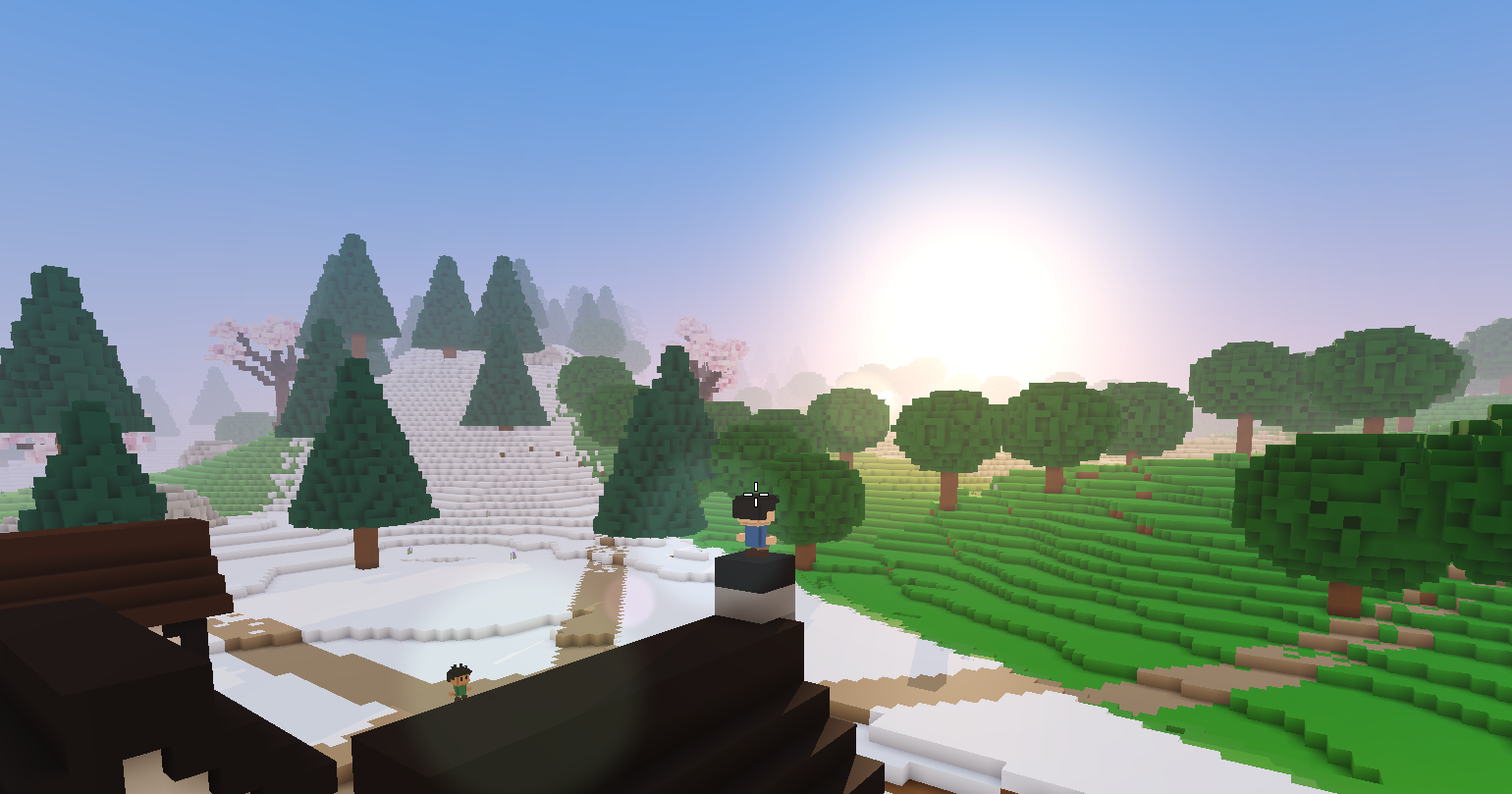 Sunrise over snowy pines and green hills, the sun low and white on the horizon.